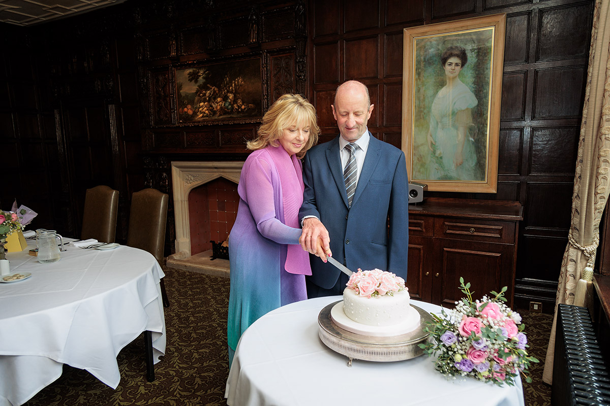 cutting wedding cake at Audleys Wood